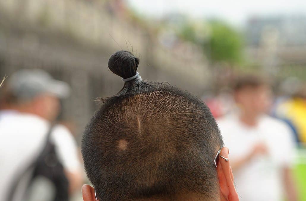 Portrait von Minh Tran mit Haarzopf